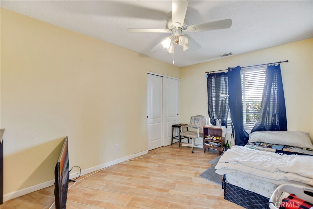 12794 Rain Shadow Road Victorville, CA 92395 - Photo 26 of 50 a bedroom with a bed and a chandelier