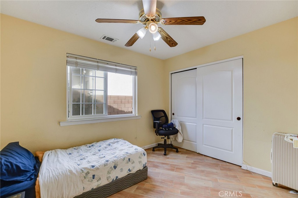 12794 Rain Shadow Road Victorville, CA 92395 - Photo 28 of 50 a bedroom with bed and a window