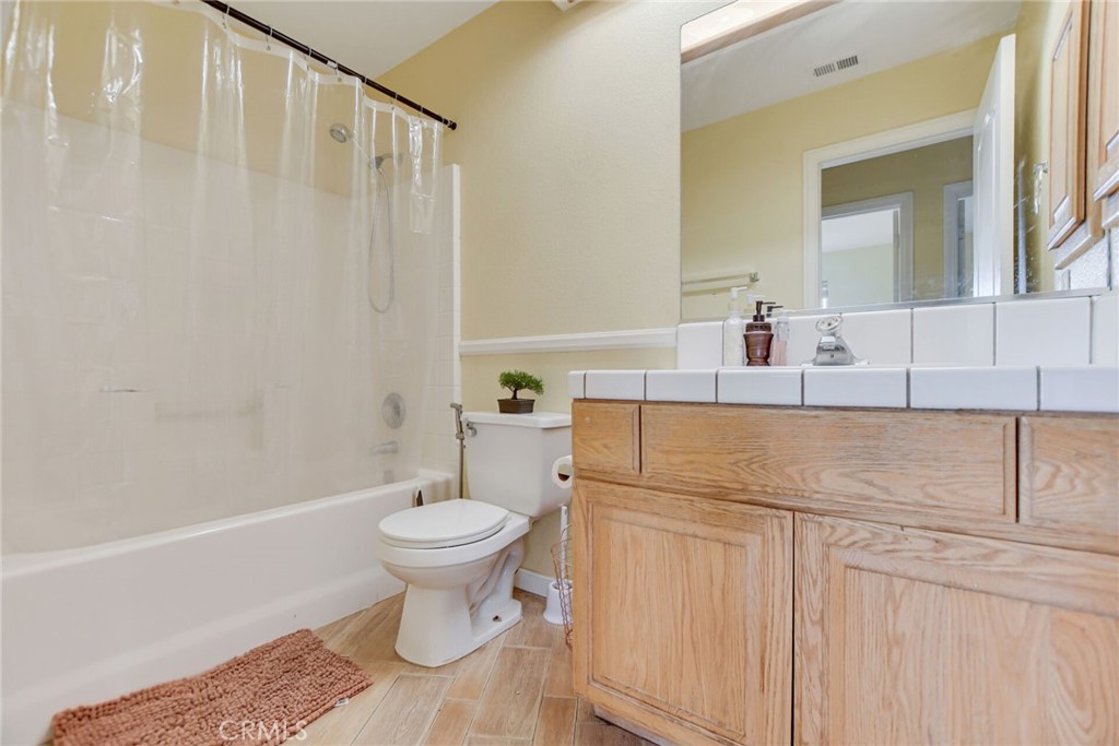 12794 Rain Shadow Road Victorville, CA 92395 - Photo 31 of 50 a bathroom with a sink a toilet and a mirror