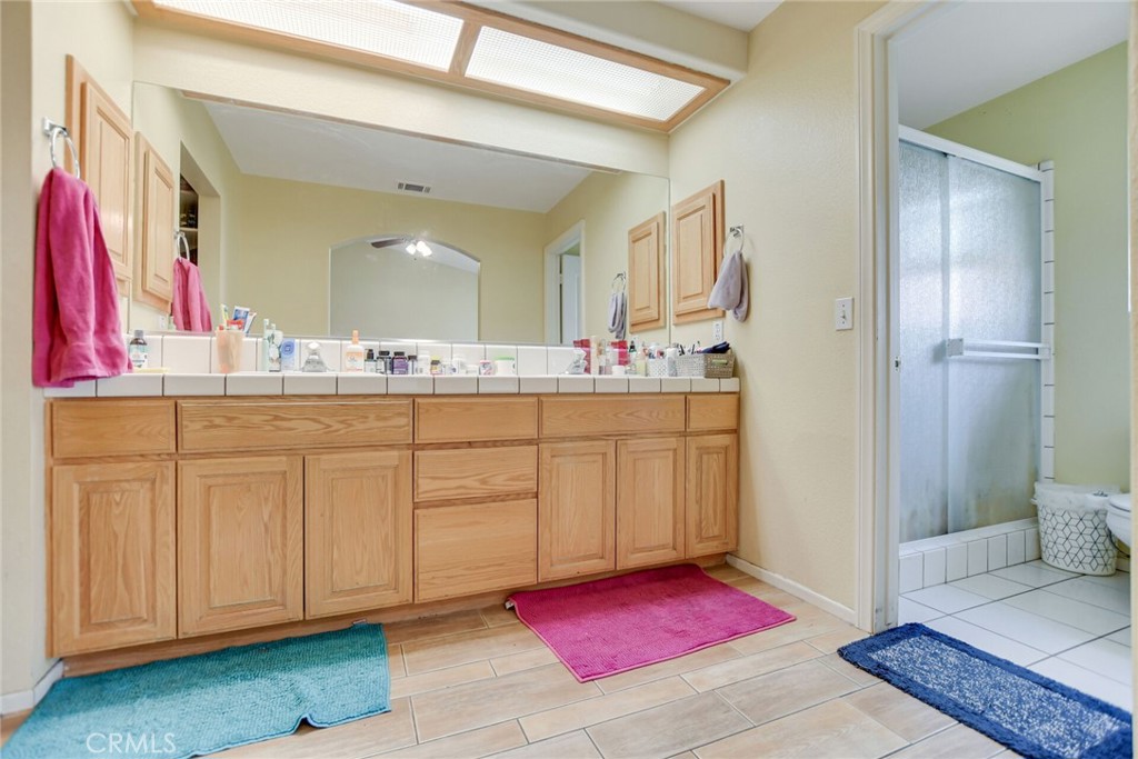 12794 Rain Shadow Road Victorville, CA 92395 - Photo 32 of 50 a bathroom with a sink vanity and a mirror
