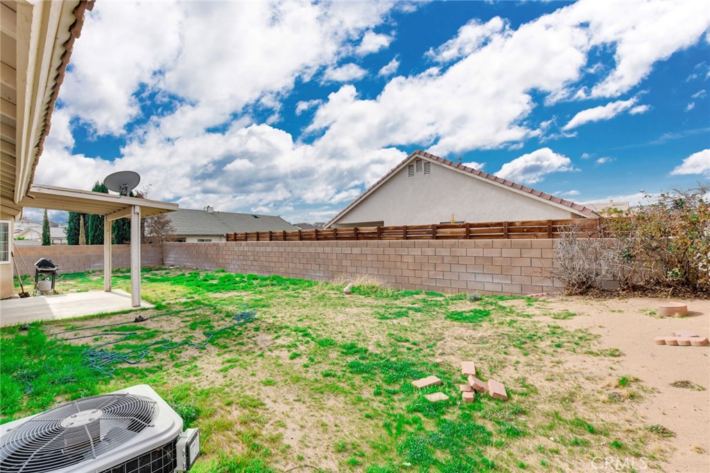12794 Rain Shadow Road Victorville, CA 92395 - Photo 34 of 50 a backyard of a house with lots of green space