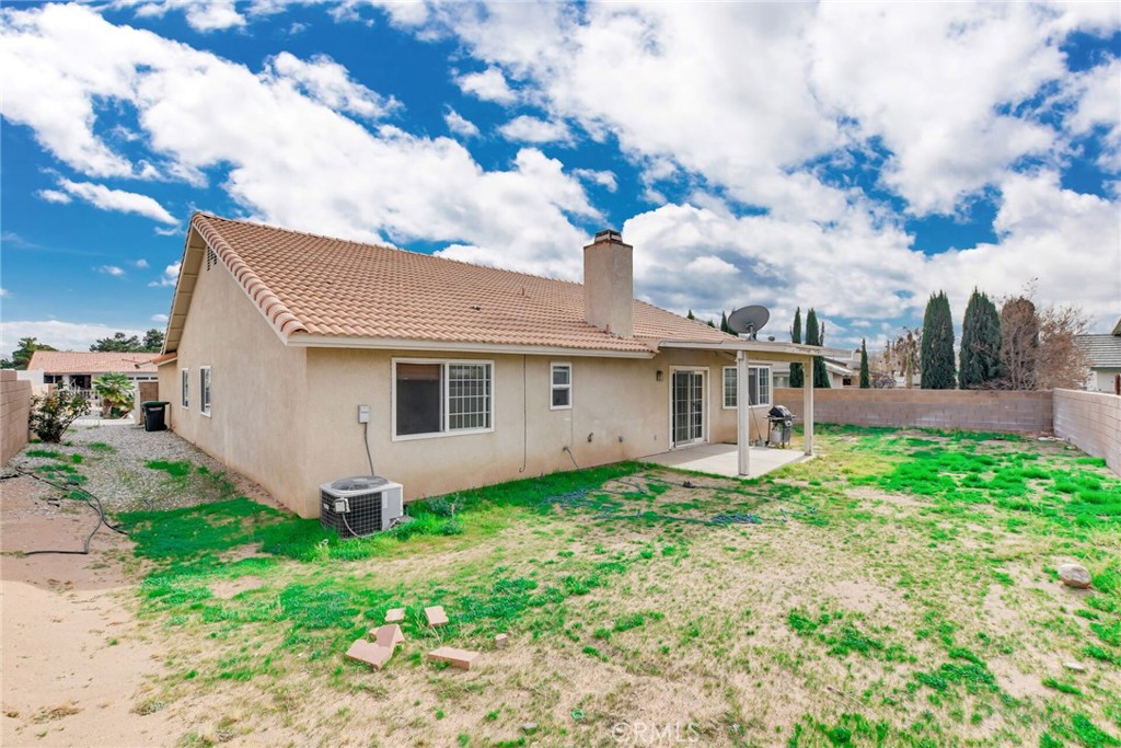 12794 Rain Shadow Road Victorville, CA 92395 - Photo 35 of 50 a front view of a house with garden