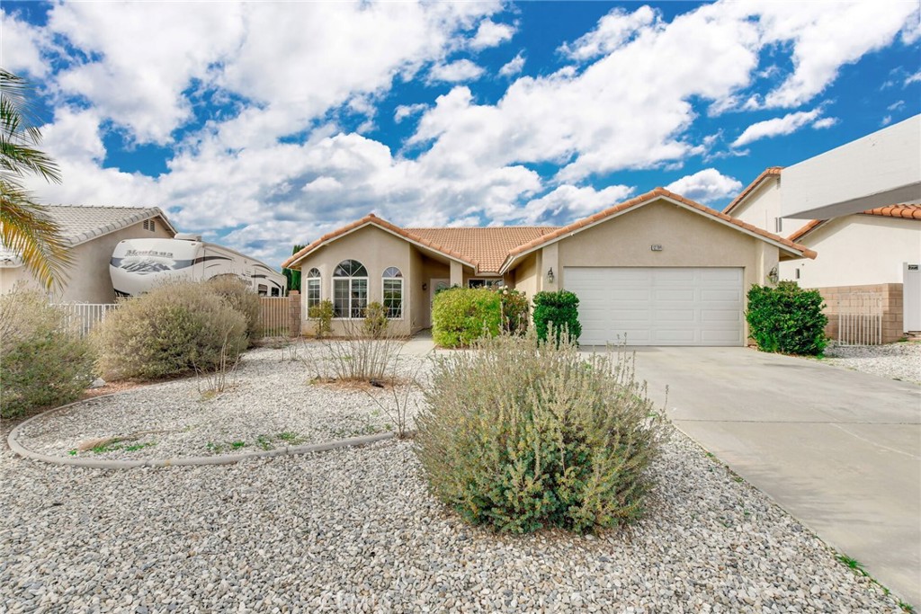 12794 Rain Shadow Road Victorville, CA 92395 - Photo 39 of 50 a front view of a house with garden