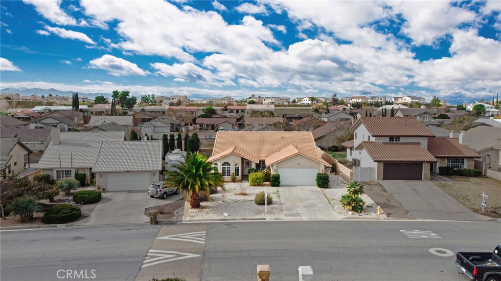 12794 Rain Shadow Road Victorville, CA 92395 - Photo 4 of 50 an aerial view of a house with a yard and garage