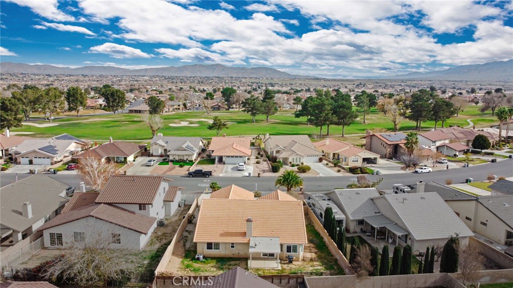 12794 Rain Shadow Road Victorville, CA 92395 - Photo 46 of 50 an aerial view of a swimming pool with lawn chairs and large trees