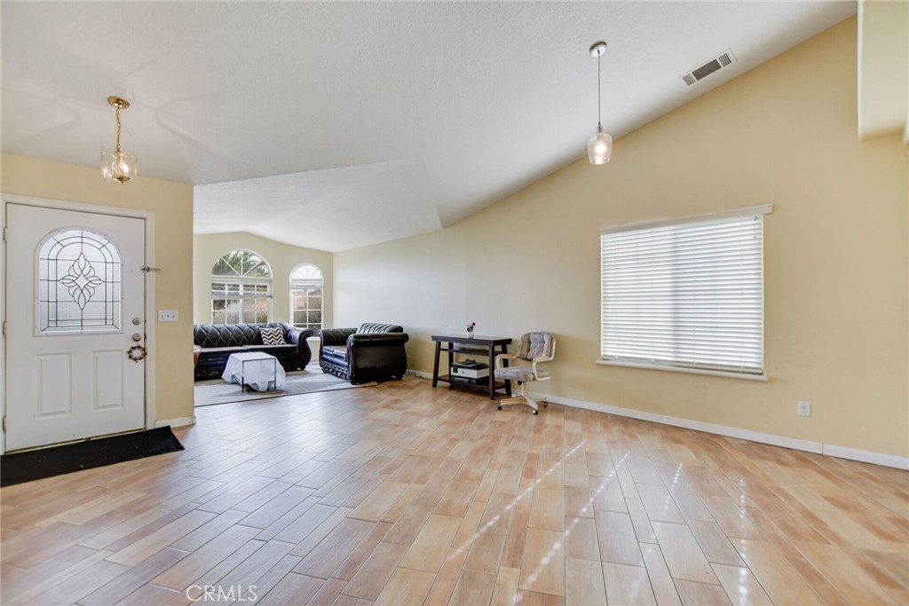 12794 Rain Shadow Road Victorville, CA 92395 - Photo 6 of 50 a view of a livingroom with couch and a window
