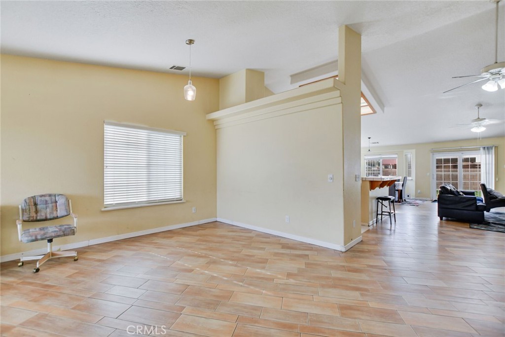 12794 Rain Shadow Road Victorville, CA 92395 - Photo 8 of 50 a view of livingroom with hardwood floor and a ceiling fan