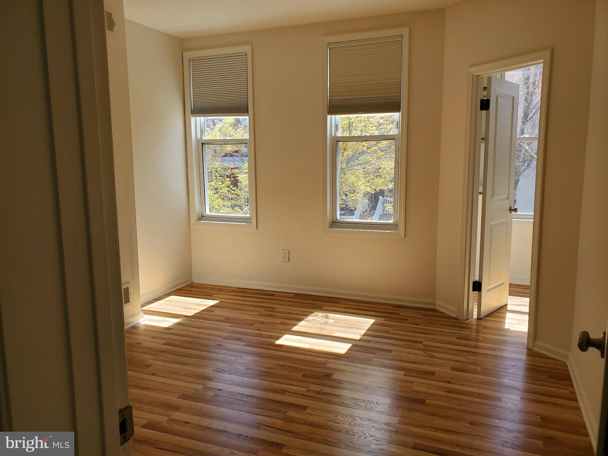 1200 D Street Northeast Washington, DC 20002 - Photo 11 of 35 a view of an empty room with window and wooden floor
