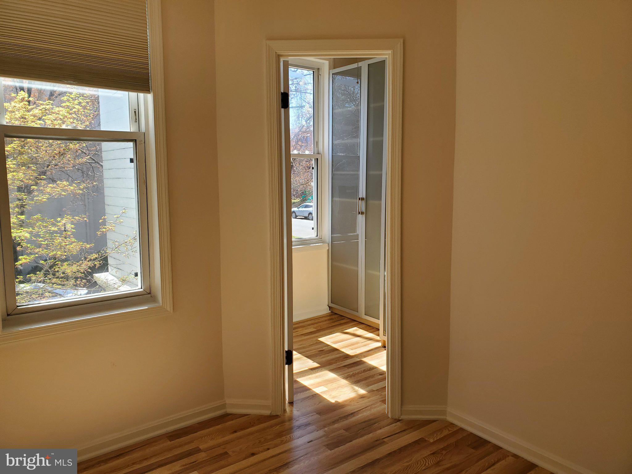 1200 D Street Northeast Washington, DC 20002 - Photo 12 of 35 a view of an empty room with wooden floor and a window