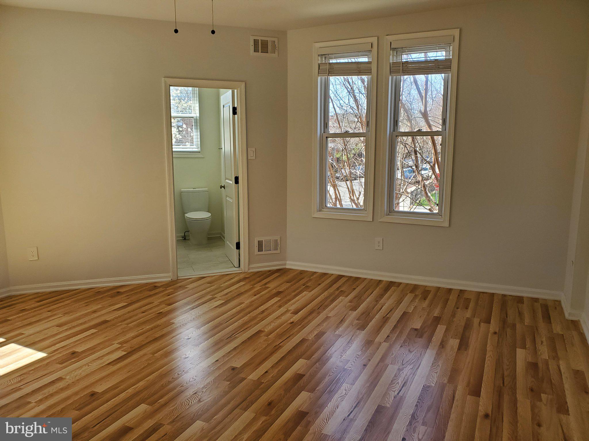 1200 D Street Northeast Washington, DC 20002 - Photo 14 of 35 a view of an empty room with wooden floor and a window
