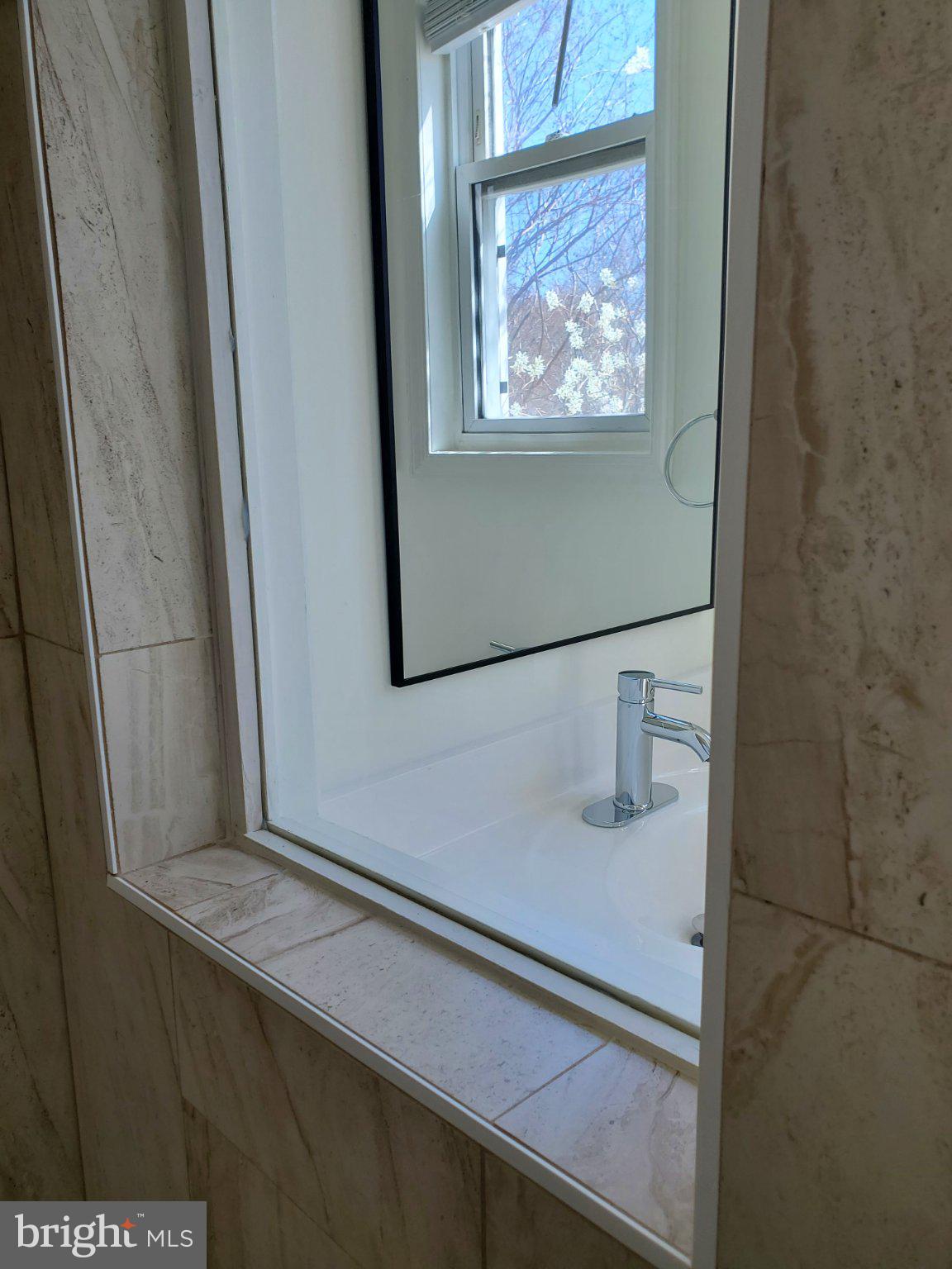 1200 D Street Northeast Washington, DC 20002 - Photo 19 of 35 a bathroom with a sink and mirror