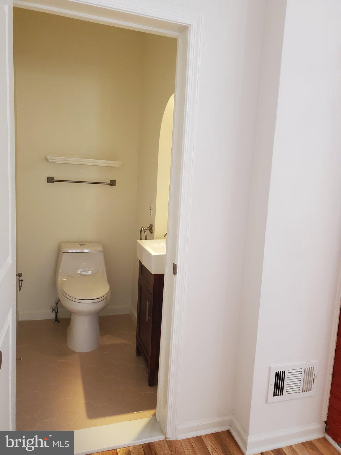 1200 D Street Northeast Washington, DC 20002 - Photo 21 of 35 a white toilet sitting in a bathroom