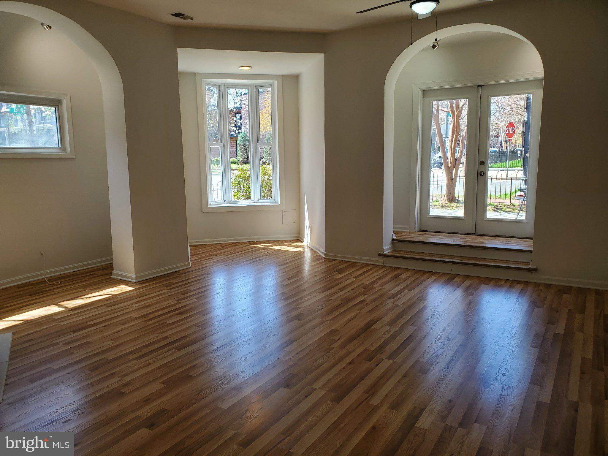 1200 D Street Northeast Washington, DC 20002 - Photo 24 of 35 an empty room with wooden floor and windows