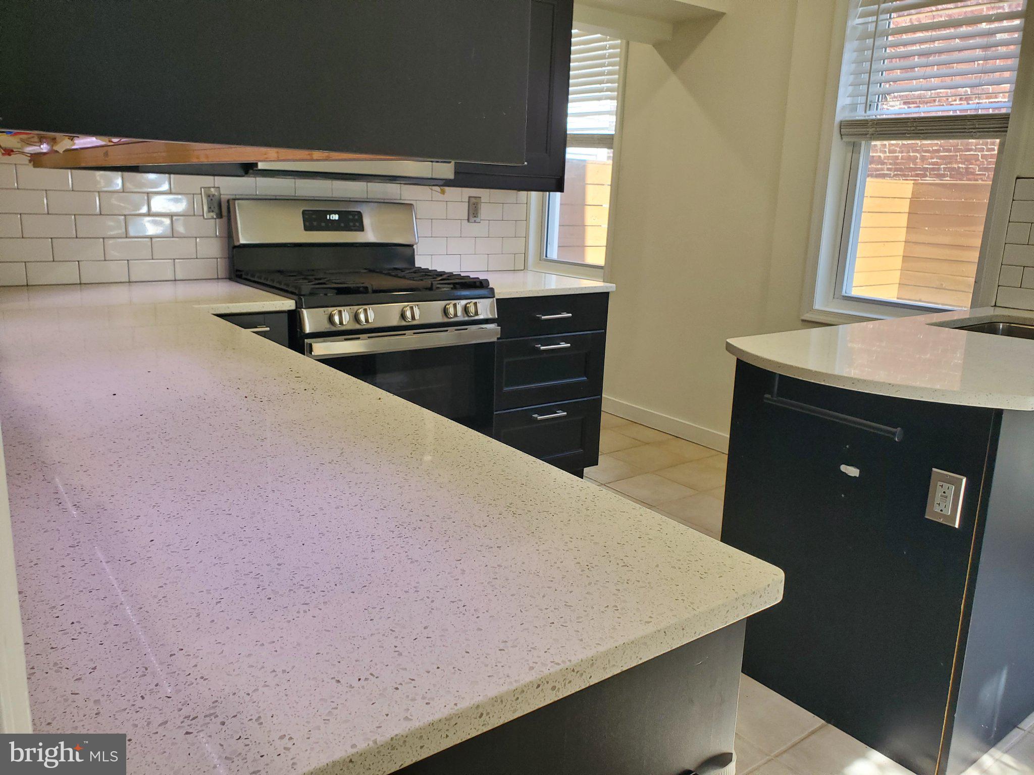 1200 D Street Northeast Washington, DC 20002 - Photo 29 of 35 a kitchen with a sink a stove and cabinets