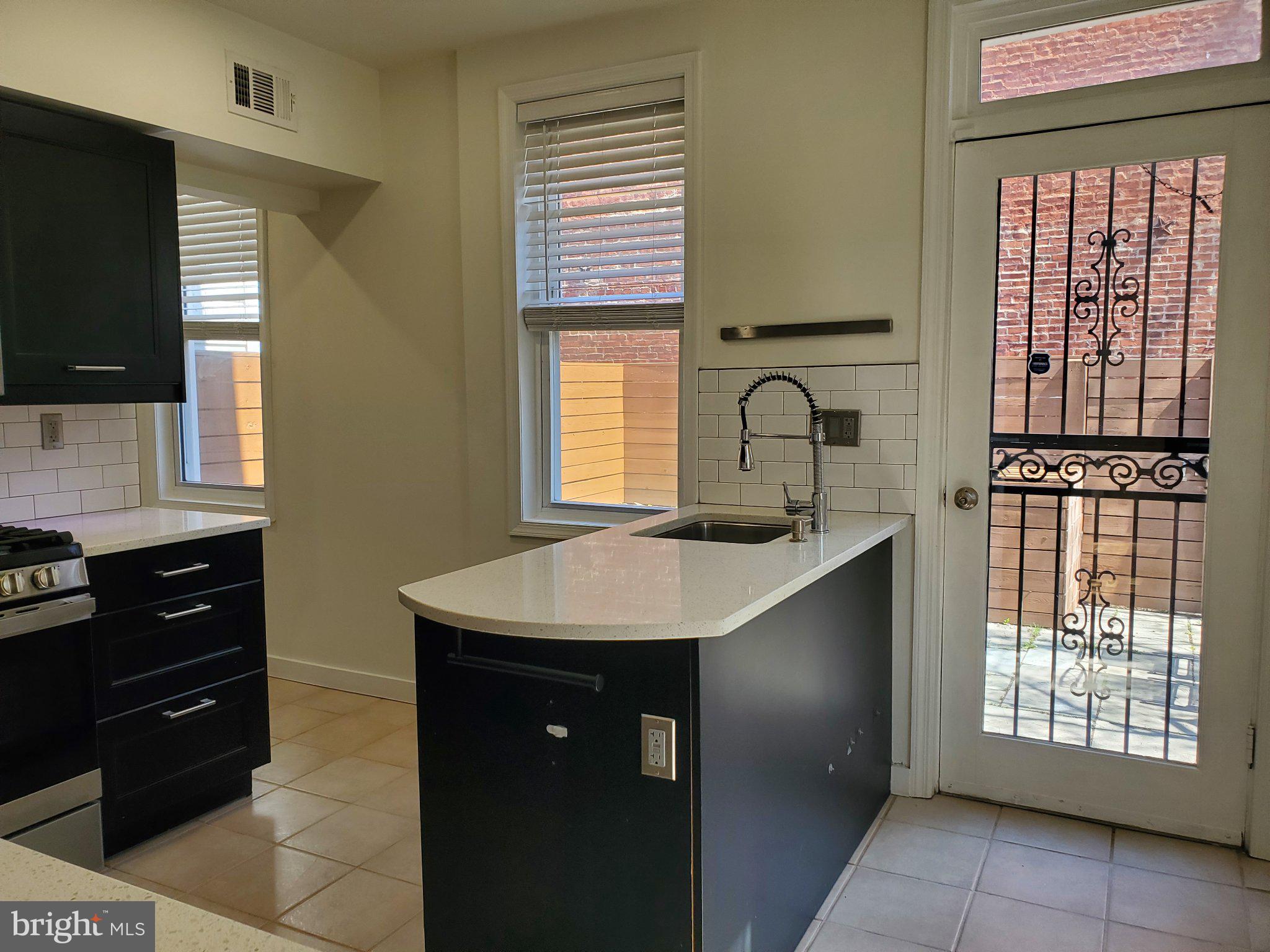 1200 D Street Northeast Washington, DC 20002 - Photo 30 of 35 a kitchen with a sink stove and cabinets