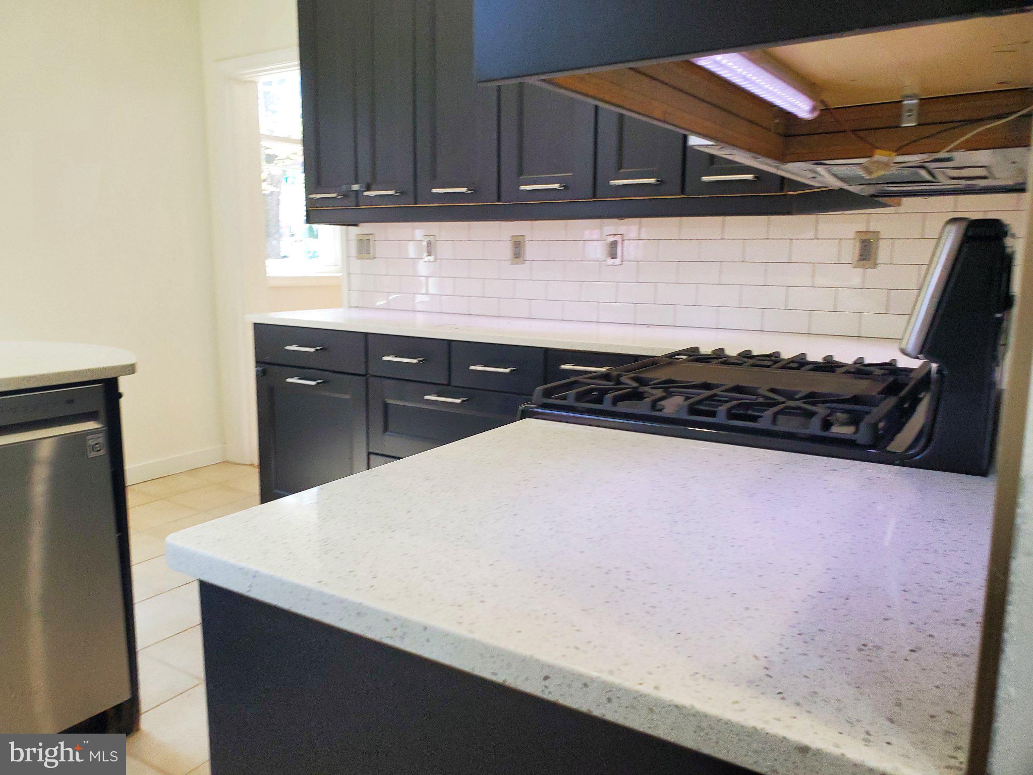 1200 D Street Northeast Washington, DC 20002 - Photo 32 of 35 a kitchen with a sink a stove top oven and cabinets