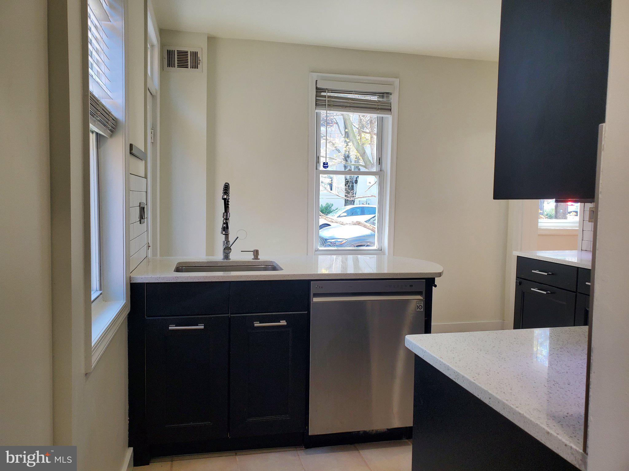 1200 D Street Northeast Washington, DC 20002 - Photo 33 of 35 a kitchen with a sink cabinets and a window