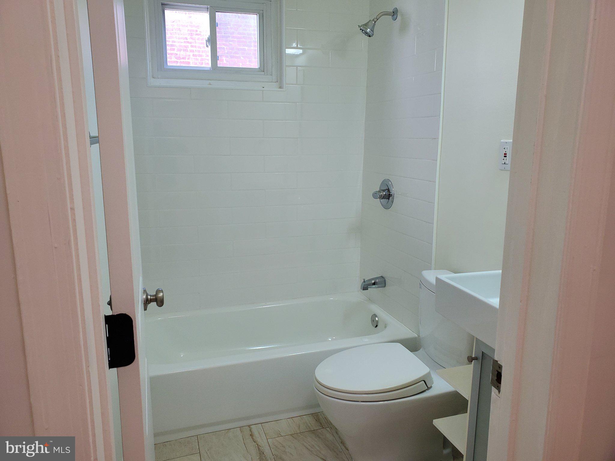 1200 D Street Northeast Washington, DC 20002 - Photo 9 of 35 a white toilet sitting next to a bath tub