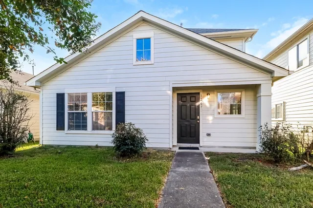 a view of house with backyard and garden