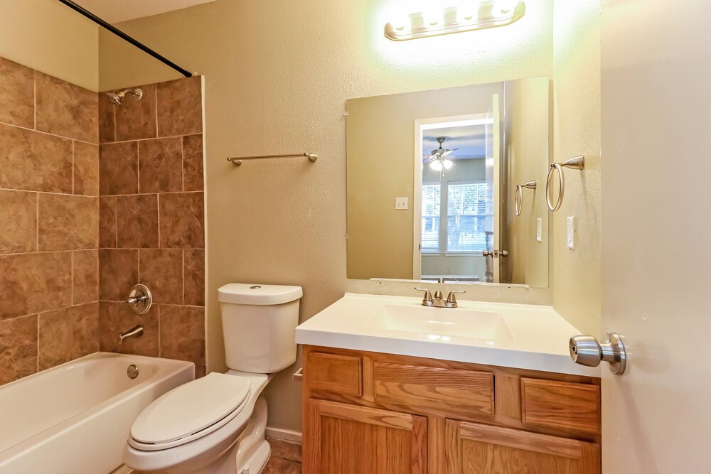 1207 Verde Trails Drive Houston, TX 77073 - Photo 11 of 17 a bathroom with a sink a toilet and shower