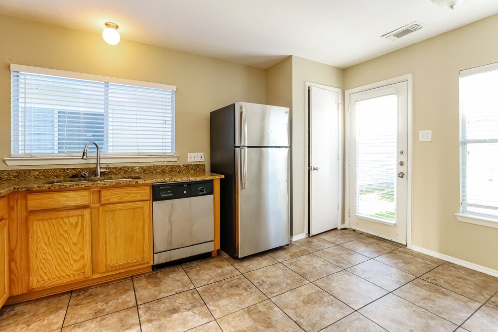 1207 Verde Trails Drive Houston, TX 77073 - Photo 8 of 17 a kitchen with stainless steel appliances granite countertop a refrigerator and a stove top oven