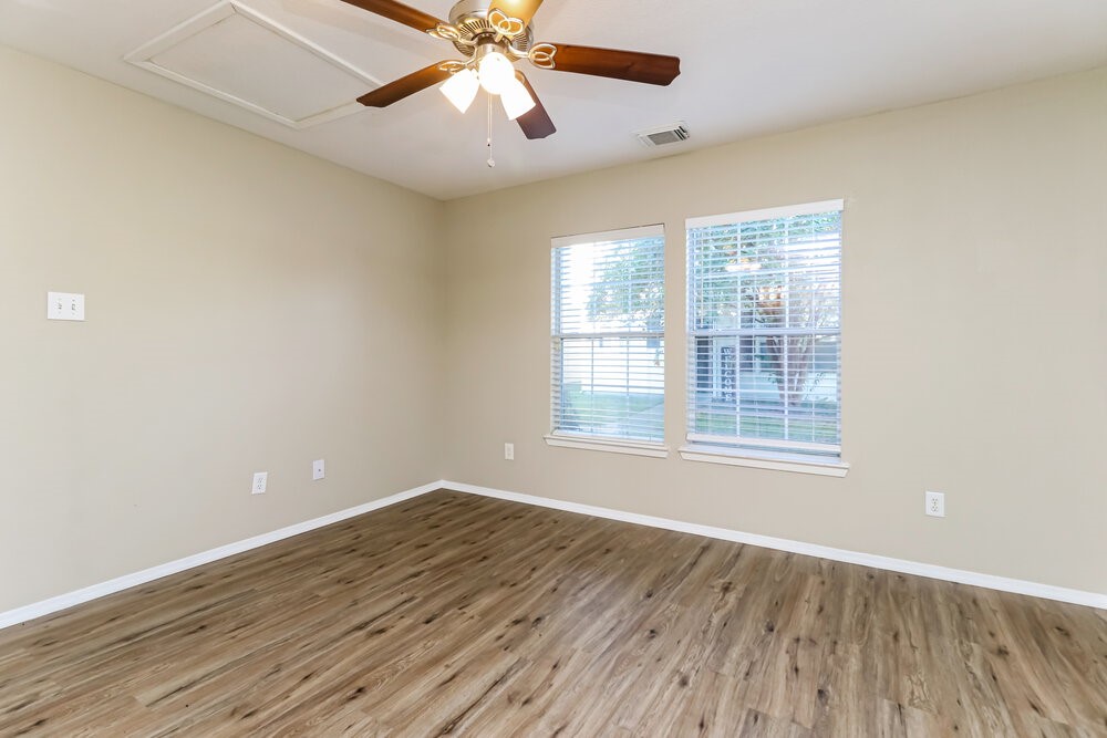 1207 Verde Trails Drive Houston, TX 77073 - Photo 9 of 17 wooden floor in an empty room with a window