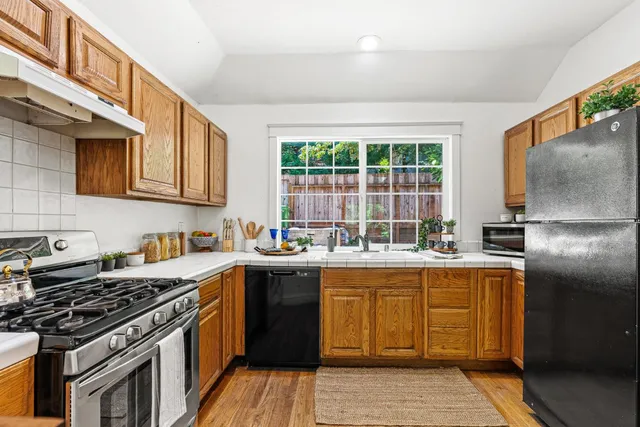 a kitchen with a stove a sink and a refrigerator
