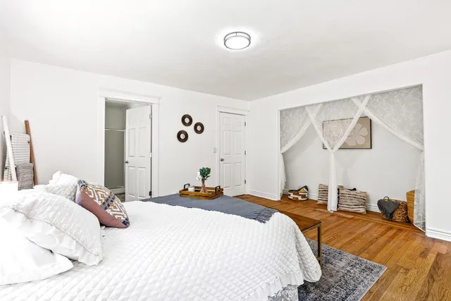 a bedroom with a bed and a painting on the wall