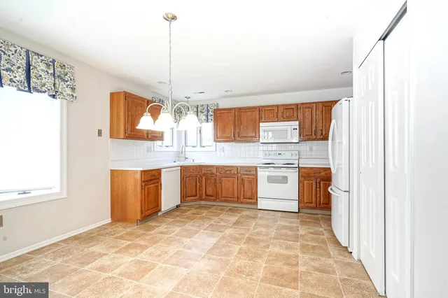 a kitchen with stainless steel appliances a sink and a refrigerator