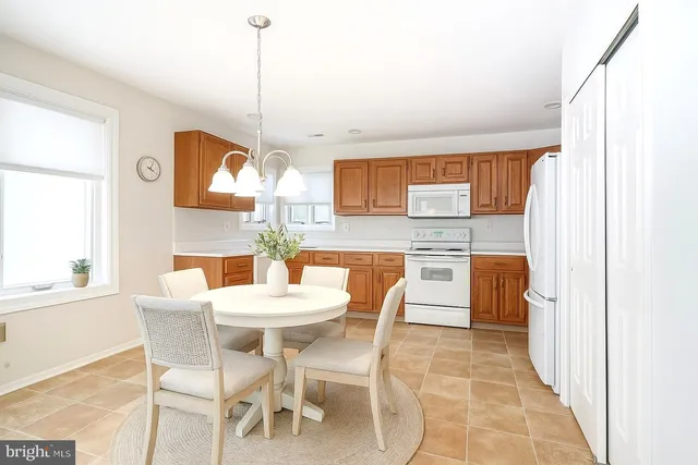 a dining room with a sink a counter and chairs