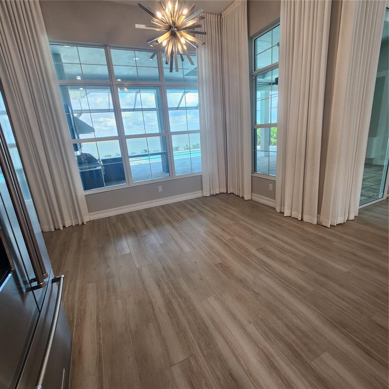 512 Blue Shell Loop Sarasota, FL 34240 - Photo 16 of 44 wooden floor in an empty room with a window