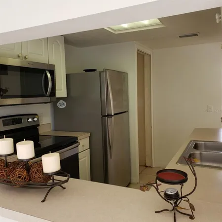 a kitchen with a sink and a refrigerator