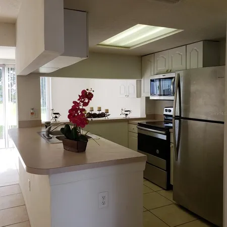 a kitchen with a sink and refrigerator