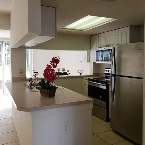a kitchen with a sink and refrigerator