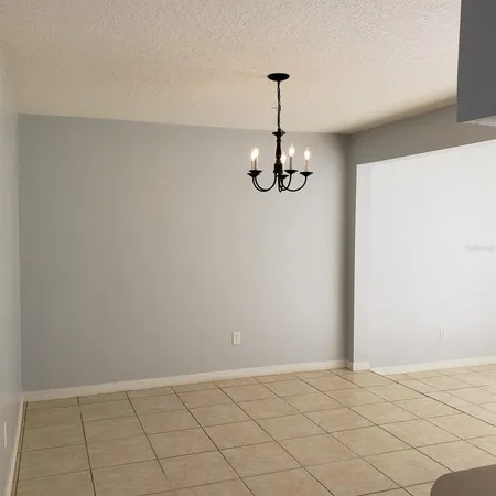a view of an empty room with a chandelier