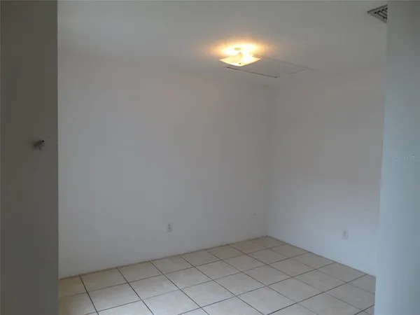 a view of an empty room and a window