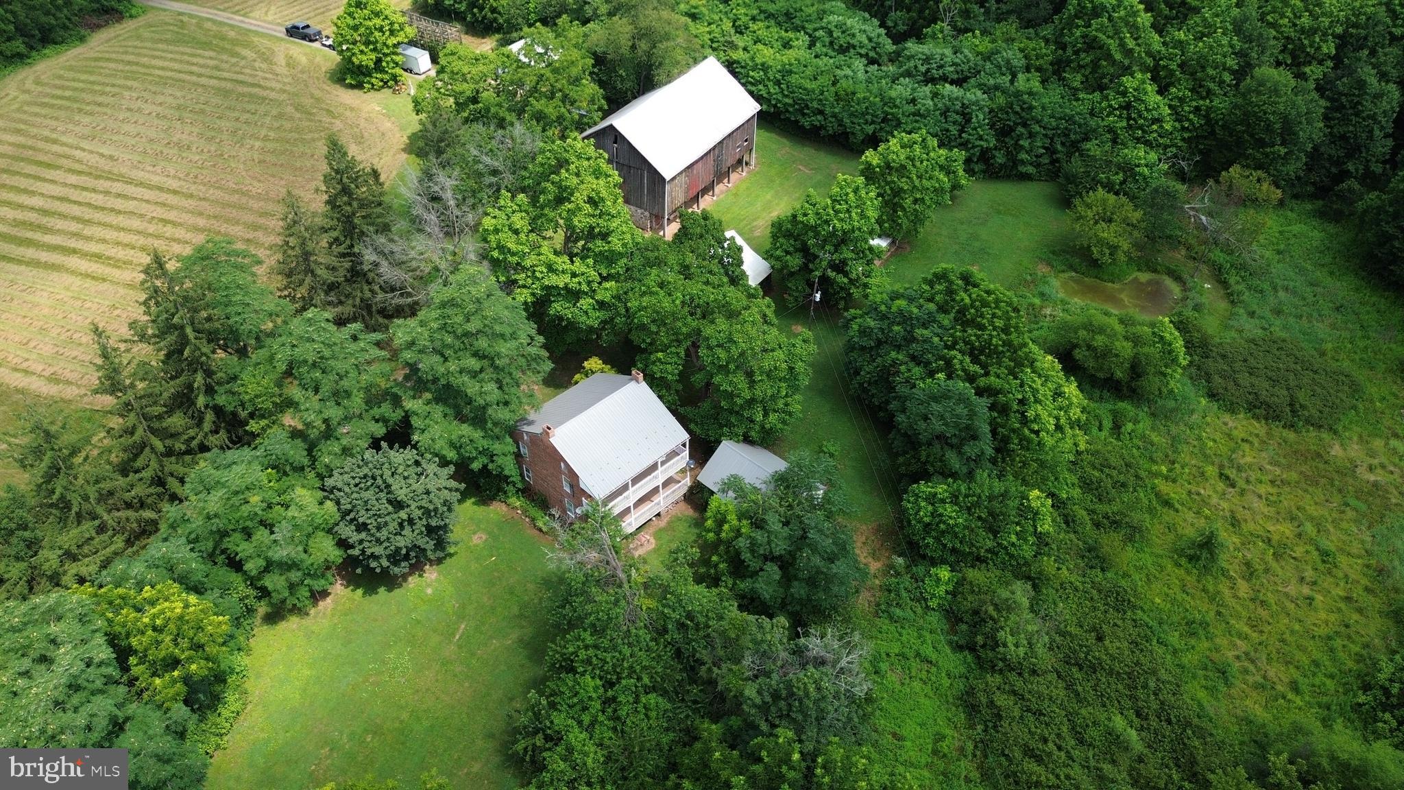 560 Basehoar Roth Road Littlestown, PA 17340 - Photo 118 of 145 a aerial view of a house with a yard and tennis court