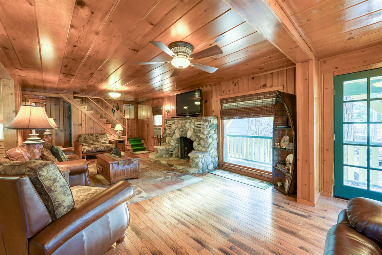 42025 Tollhouse Road Shaver Lake, CA 93664 - Photo 31 of 64 a living room with lots of furniture and a fireplace