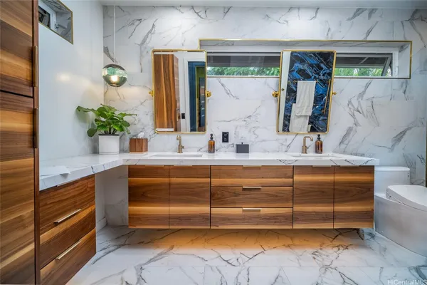 a bathroom with a sink a toilet and a shower