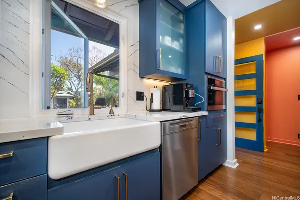 a kitchen with stainless steel appliances a sink and a large window