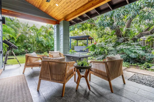 a view of a patio with couches table and chairs and potted plants