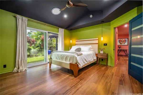 a bed sitting in a spacious bedroom next to a window