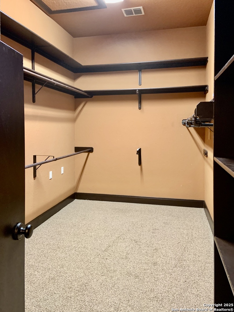 19940 Scenic Loop Road San Antonio, TX 78255 - Photo 11 of 34 a view of a room with rack on the wall