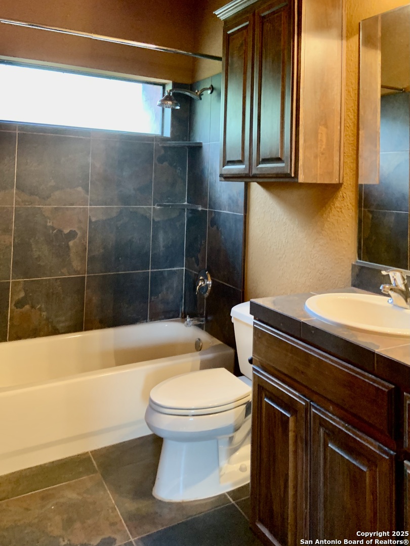 19940 Scenic Loop Road San Antonio, TX 78255 - Photo 27 of 34 a bathroom with a sink toilet and shower