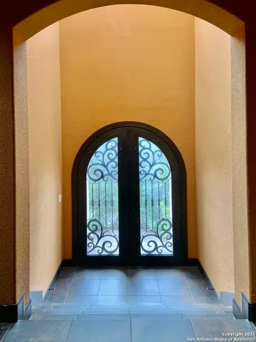 a view of front door with a mirror