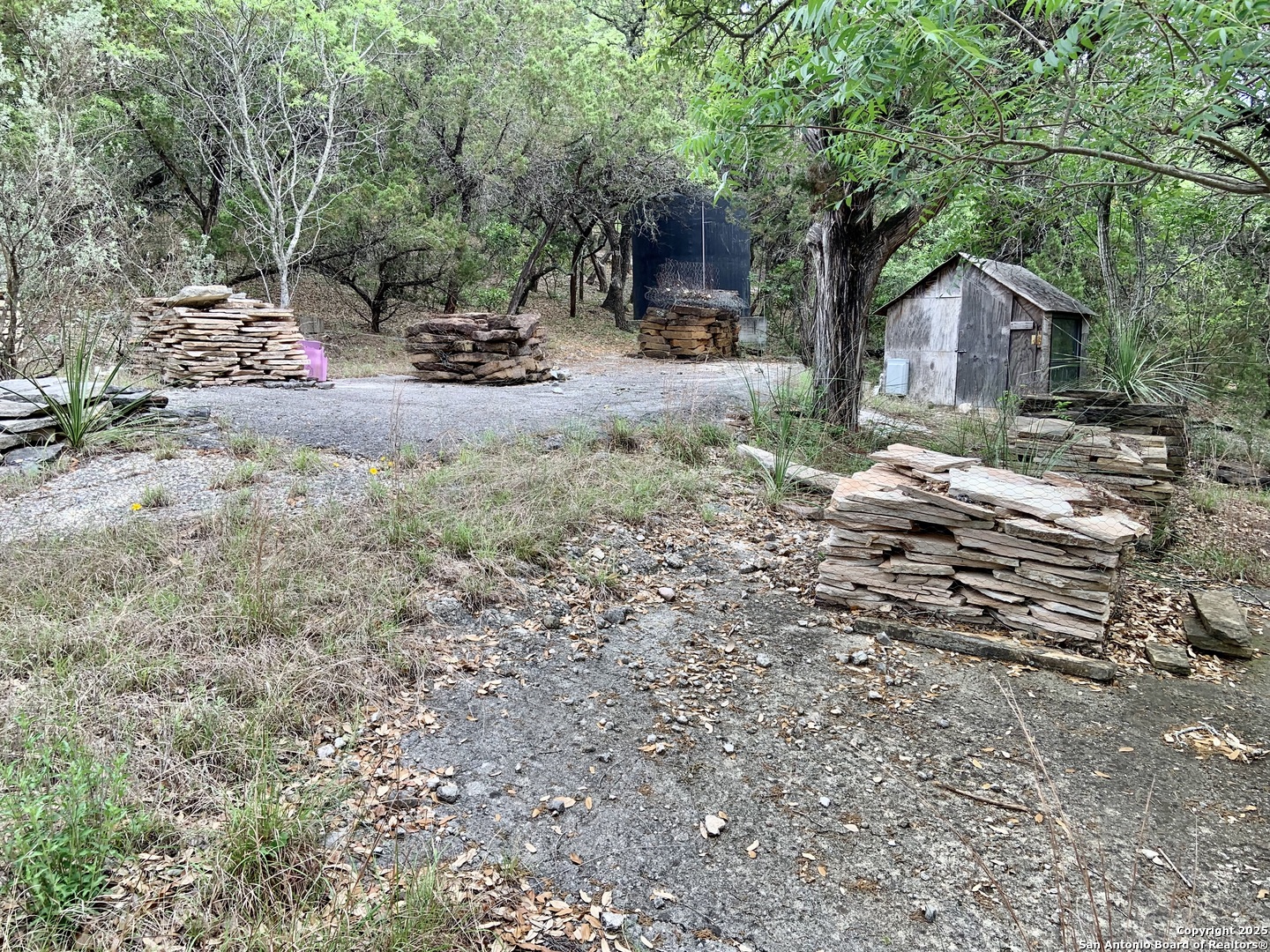 19940 Scenic Loop Road San Antonio, TX 78255 - Photo 31 of 34 a backyard of a house with fire pit and outdoor seating