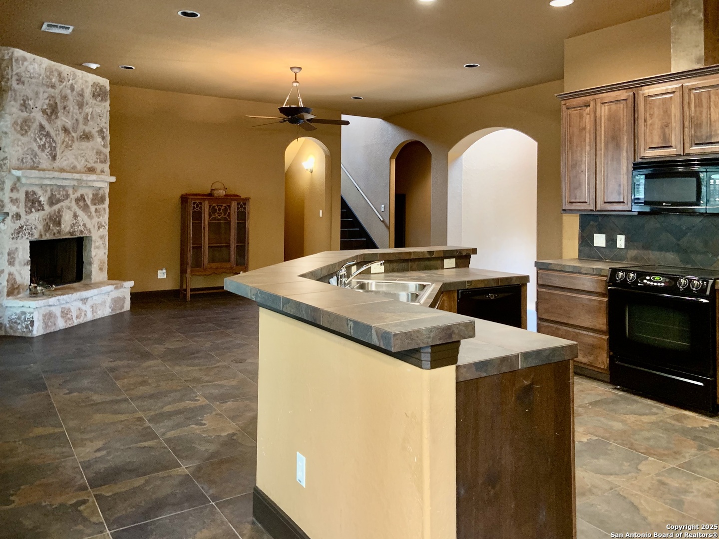 19940 Scenic Loop Road San Antonio, TX 78255 - Photo 6 of 34 a kitchen with stainless steel appliances granite countertop a sink a stove and cabinets