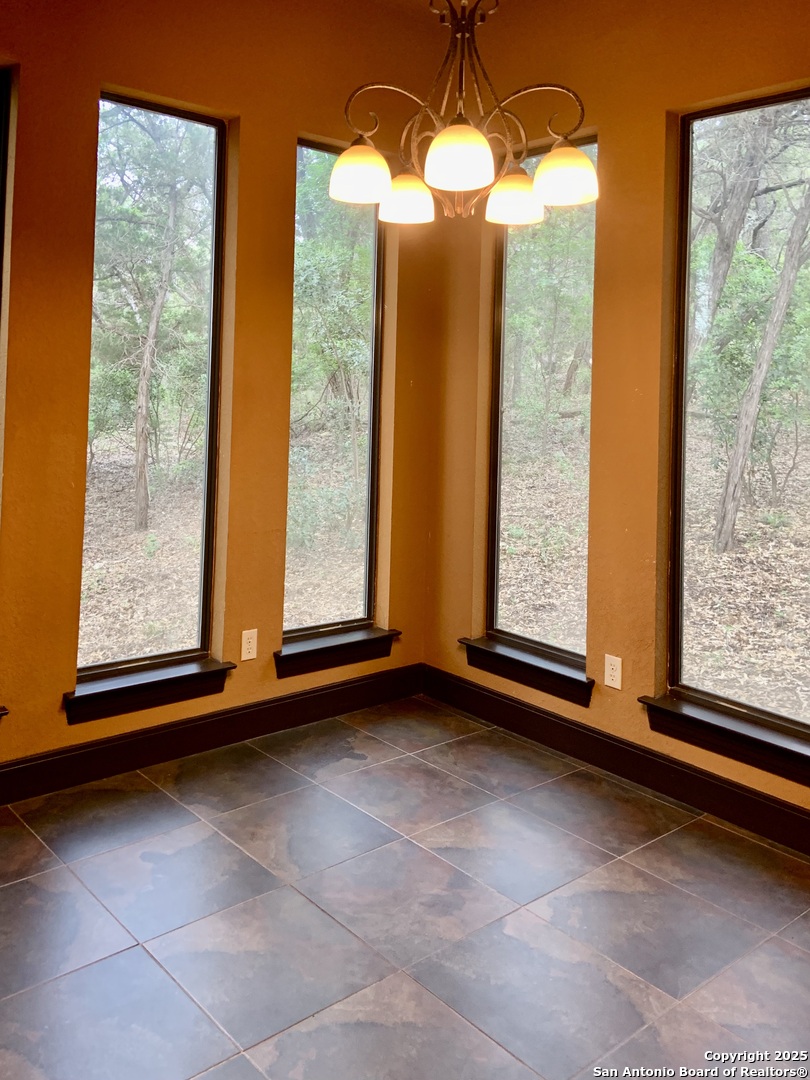 19940 Scenic Loop Road San Antonio, TX 78255 - Photo 7 of 34 a view of room with window and floor to ceiling window