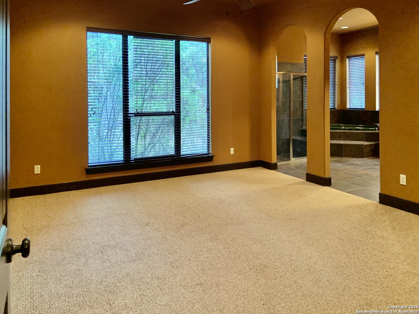 19940 Scenic Loop Road San Antonio, TX 78255 - Photo 8 of 34 a view of an empty room with a fireplace and a window