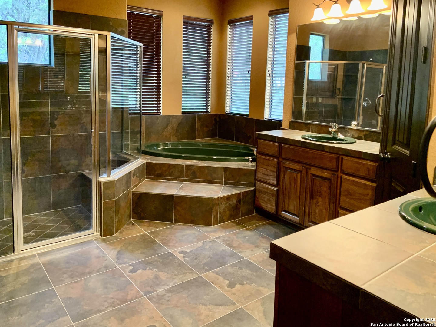 19940 Scenic Loop Road San Antonio, TX 78255 - Photo 9 of 34 a bathroom with a tub and a sink